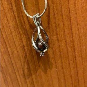 Real black pearl necklace with caged charm